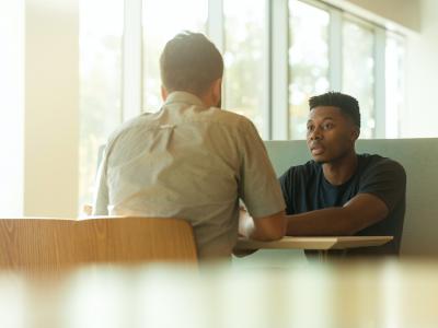 Men in business advice meeting. Photo by LinkedIn Sales Navigator on Unsplash. 